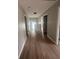 Hallway features wood floors, neutral paint, and well-lit open space at 308 Tidal Rice Ct, Wando, SC 29492