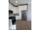 Modern kitchen featuring stainless steel appliances and sleek white cabinetry at 308 Tidal Rice Ct, Wando, SC 29492