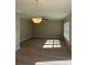 Bright living room featuring hardwood floors, ceiling fan, and a decorative chandelier at 308 Tidal Rice Ct, Wando, SC 29492