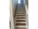 Wooden staircase featuring white risers, modern railing, and a decorative trim at 308 Tidal Rice Ct, Wando, SC 29492