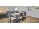 Open-concept dining area with wood-style floors flowing into the living room with a comfortable seating arrangement at 325 Coral Sunset Way, Summerville, SC 29486