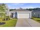 Charming single-story home with a two-car garage, well-manicured lawn, and a welcoming entrance at 325 Coral Sunset Way, Summerville, SC 29486
