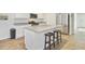 Modern kitchen island with counter seating, a stainless steel fridge, and bright white cabinetry at 325 Coral Sunset Way, Summerville, SC 29486