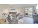 Inviting living room with sliding glass doors to the backyard and comfortable seating area with recliner chairs at 325 Coral Sunset Way, Summerville, SC 29486