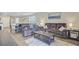 Wide shot of an open-concept living space with comfortable seating and a dining area with stainless steel appliances visible at 325 Coral Sunset Way, Summerville, SC 29486