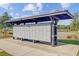 Community mailboxes under a covered shelter featuring a convenient parking area with a view of the pool at 325 Coral Sunset Way, Summerville, SC 29486