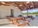 Pool pavilion with wooden picnic tables, beamed ceiling, and ample lighting providing an inviting space for outdoor gatherings at 325 Coral Sunset Way, Summerville, SC 29486