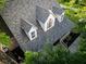 An aerial view of the roofline on a multi-story brick home surrounded by mature trees and landscaping at 3385 Wayland Dr, Ladson, SC 29456