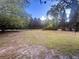 Large backyard with a chain link fence, beautiful trees and plenty of grass at 3385 Wayland Dr, Ladson, SC 29456