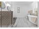 Bright bathroom with marble floors, freestanding tub, stylish tile and shower with glass at 3385 Wayland Dr, Ladson, SC 29456