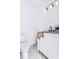 Modern powder room featuring a white vanity with gold fixtures and marble flooring at 3385 Wayland Dr, Ladson, SC 29456