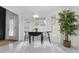 Bright dining area with a drop leaf table, white marble floors, and plantation shutters at 3385 Wayland Dr, Ladson, SC 29456