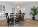 Dining room with hardwood floors, large windows, stylish chandelier, and a dining table with six chairs at 3385 Wayland Dr, Ladson, SC 29456