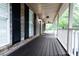 Spacious front porch featuring dark wooden flooring, classic lighting, and a ceiling fan at 3385 Wayland Dr, Ladson, SC 29456