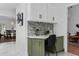 Built-in kitchen desk area with white cabinets, modern backsplash, and stylish decor at 3385 Wayland Dr, Ladson, SC 29456