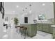 Spacious kitchen featuring a center island with seating, white cabinets, and modern lighting fixtures at 3385 Wayland Dr, Ladson, SC 29456