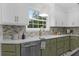 Kitchen featuring a stainless steel sink, green cabinetry, and white countertop at 3385 Wayland Dr, Ladson, SC 29456