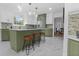 Open-concept kitchen with white and green cabinets, stainless steel appliances, and a center island at 3385 Wayland Dr, Ladson, SC 29456