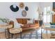 Stylish living room featuring a leather sofa, decorative wall art, and modern lighting at 3385 Wayland Dr, Ladson, SC 29456