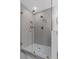 Contemporary walk-in shower with glass doors, gray and white tile and brushed gold fixtures at 3385 Wayland Dr, Ladson, SC 29456