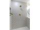 Charming walk-in shower featuring designer tile, recessed niche and gold fixtures at 3385 Wayland Dr, Ladson, SC 29456