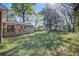 A spacious backyard with mature trees and lush greenery with a wooden deck attached to the house at 3627 Marginal Rd, Mount Pleasant, SC 29466