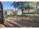 The home's backyard features a well-manicured lawn, mature trees, and a wooden deck at 3627 Marginal Rd, Mount Pleasant, SC 29466