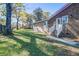 A view of the back of the house showing the brick and siding exterior, stairs, and a spacious yard at 3627 Marginal Rd, Mount Pleasant, SC 29466