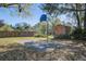 Backyard view of basketball court, wooden shed, and a well-maintained lawn at 3627 Marginal Rd, Mount Pleasant, SC 29466