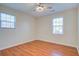 Bright bedroom features hardwood floors, a ceiling fan, and natural light from two windows at 3627 Marginal Rd, Mount Pleasant, SC 29466