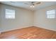 Bright bedroom features hardwood floors, a ceiling fan, and natural light from two windows at 3627 Marginal Rd, Mount Pleasant, SC 29466