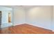 Open room featuring hardwood flooring, neutral walls, and access to kitchen and other rooms, ready for personalization at 3627 Marginal Rd, Mount Pleasant, SC 29466