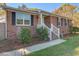 Charming brick home with black shutters, manicured landscaping, and a welcoming white railed front porch entrance at 3627 Marginal Rd, Mount Pleasant, SC 29466