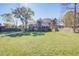 Traditional brick home with a large front yard, paved driveway, and mature trees offering shade at 3627 Marginal Rd, Mount Pleasant, SC 29466
