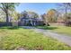 Traditional brick home with a large front yard, paved driveway, and mature trees offering shade at 3627 Marginal Rd, Mount Pleasant, SC 29466
