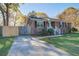 Charming brick home with lush front yard, a driveway, and a wooden fence for privacy at 3627 Marginal Rd, Mount Pleasant, SC 29466