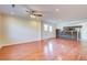 Bright living room boasts hardwood floors, neutral walls, recessed lighting, ceiling fan, and an open layout to the kitchen at 3627 Marginal Rd, Mount Pleasant, SC 29466