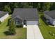 Beautiful aerial view of a home with a well-manicured lawn, driveway, and a two-car garage at 3806 Sourwood Ct, Ladson, SC 29456