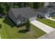 Scenic aerial view of a suburban home with a lush lawn, driveway, and tidy landscaping at 3806 Sourwood Ct, Ladson, SC 29456