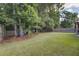 Large backyard featuring mature trees and a wooden fence, providing privacy and a natural setting at 3806 Sourwood Ct, Ladson, SC 29456