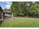 Spacious backyard with well-maintained lawn, a covered patio, and a charming hammock for relaxation at 3806 Sourwood Ct, Ladson, SC 29456