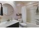 Bathroom featuring a round mirror, bright light, and shower/tub at 3806 Sourwood Ct, Ladson, SC 29456
