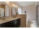 Bathroom with double vanity sinks, dark cabinets, and lots of natural light at 3806 Sourwood Ct, Ladson, SC 29456