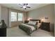 Spacious bedroom featuring a ceiling fan, neutral carpet, and dark furniture at 3806 Sourwood Ct, Ladson, SC 29456
