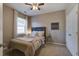 Bedroom features a ceiling fan, side table, neutral tones, and lots of light at 3806 Sourwood Ct, Ladson, SC 29456