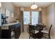 Bright dining area with round table, seating for four, and natural light from the adjacent window at 3806 Sourwood Ct, Ladson, SC 29456