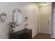 Inviting entryway with stylish decor, a round mirror, and dark wood floors at 3806 Sourwood Ct, Ladson, SC 29456