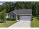 Charming home with a two-car garage, a well-kept lawn, and freshly manicured shrubs at 3806 Sourwood Ct, Ladson, SC 29456