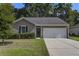 The home features a tidy front yard, manicured bushes, and a two-car driveway at 3806 Sourwood Ct, Ladson, SC 29456