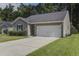 Charming single-story home featuring a two-car garage, neutral siding, and a well-manicured lawn at 3806 Sourwood Ct, Ladson, SC 29456